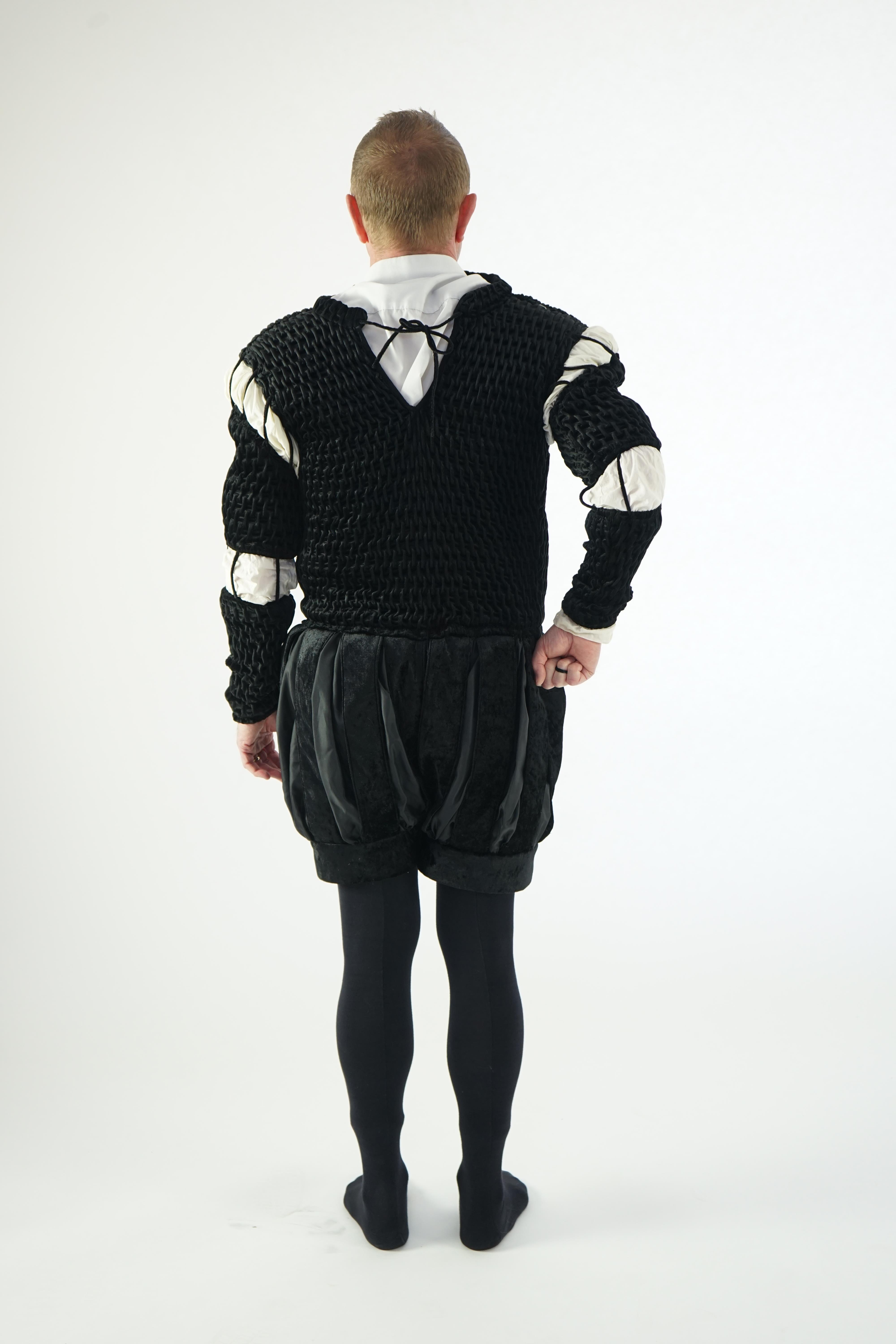 A man's Elizabethan style black smocked velvet and white trim costume, with cod piece and black tights. Ex Royal Opera House Sale.